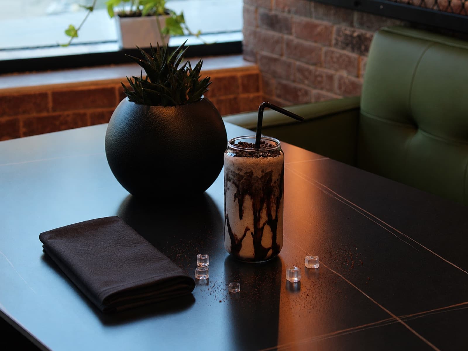 Iced chocolate drink on a café table by the window