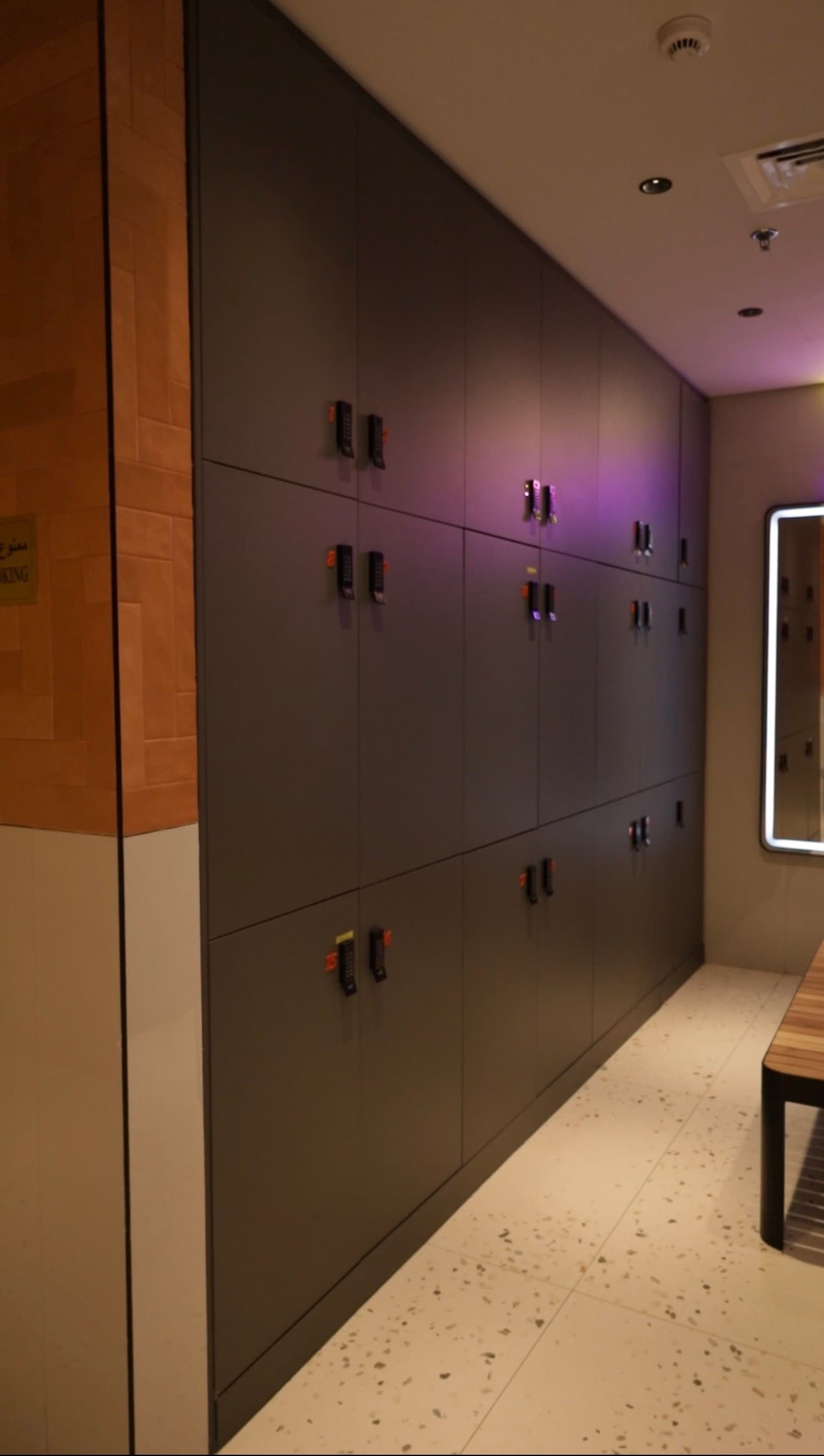 Changing room wall of digital-lock lockers with accent lighting